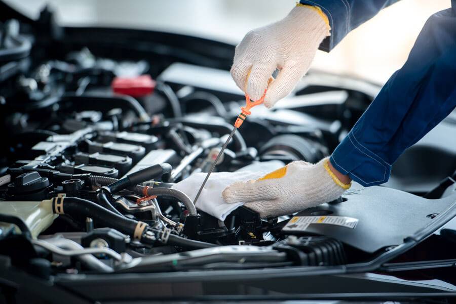 Mechanic checking the engine during a car service in Romford